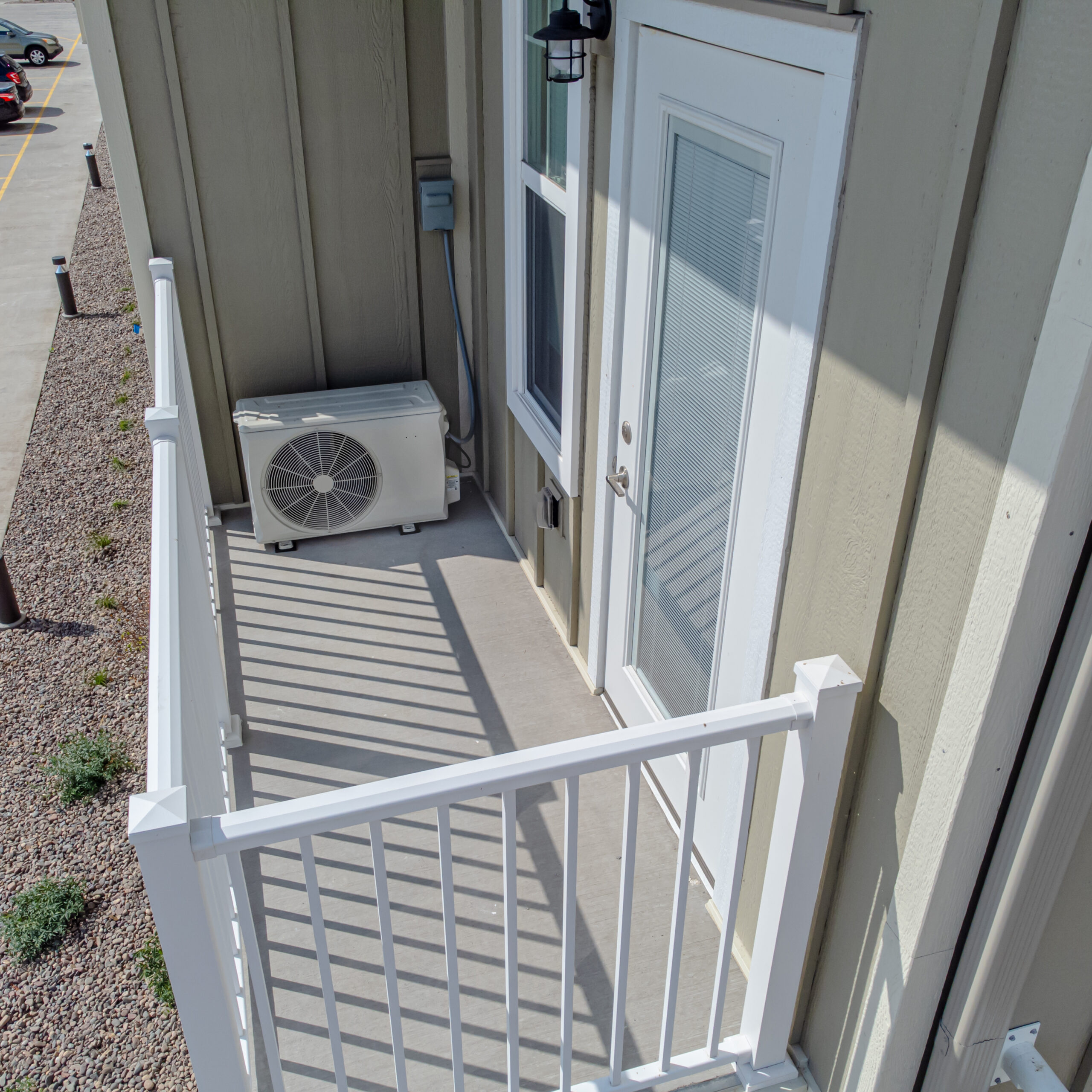 Outdoor air source heat pump unit on a residential balcony for a 2026 heat pump tax credits and rebates guide.